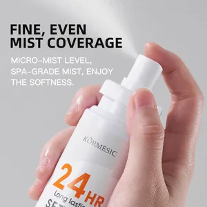Macro view of a hand pressing the nozzle to release a fine, even mist of 24h setting spray