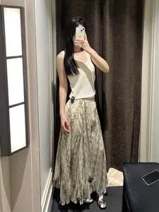 Elegant snakeskin pattern long skirt with irregular hem shown on model in fitting room