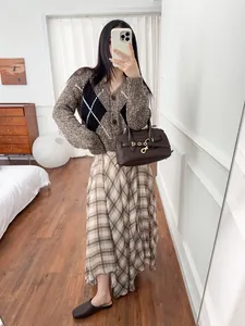 Elegant French style flowy brown plaid midi skirt with irregular hem shown on model