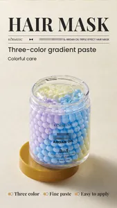 Detailed close-up of three-color gradient hair mask paste with argan oil for repair and care