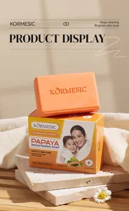 Close-up of KORMESIC Papaya Brightening Soap with ingredients and weight details.