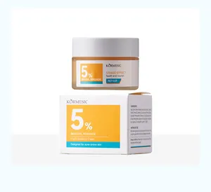 Macro detail of KORMESIC 5% Benzoyl Peroxide Night Soothing Cream and its product box