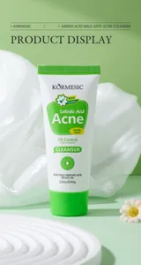 Close-up of KORMESIC Salicylic Acid Acne Facial Cleanser tube on green background.