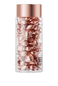Detailed view of KORMESIC facial serum capsules showing ingredient labels and rose gold texture