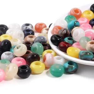 Detailed view of colorful acrylic beads with marbleized jade-like texture and large holes