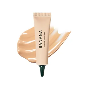 Banana Conceal Eye Cream in a nude tube with a smooth cream texture smear background