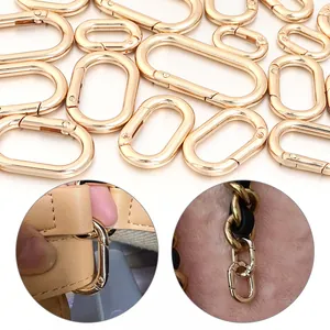 Detailed macro view of golden oval spring gate rings used as connectors for handbag straps