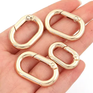 Detailed close-up showing four premium golden zinc alloy oval spring carabiners for bags.