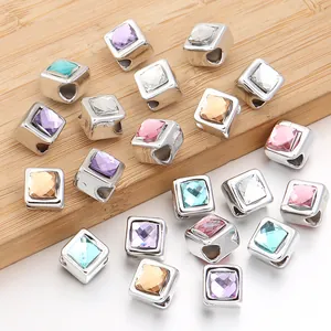 Close-up of cube beads with square resin gems and heart-shaped side cutouts