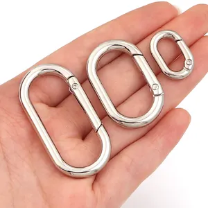 Close-up of three sizes of silver oval spring buckles for bag and jewelry accessories