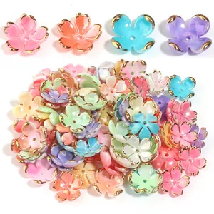 Close-up of assorted colorful five-petal flower beads with gold edges for jewelry DIY