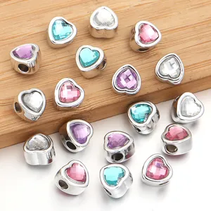 Macro detail of multi-colored heart resin gemstone beads with large holes for DIY charm bracelets