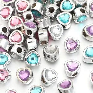 Close-up of heart-shaped large hole beads with colorful faceted resin gemstones