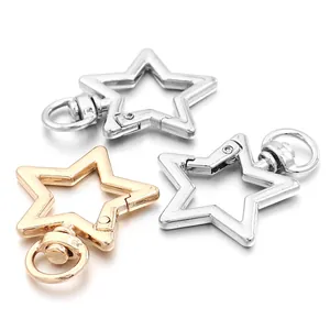 Detail view of gold and silver star-shaped zinc alloy spring clasps for keychains