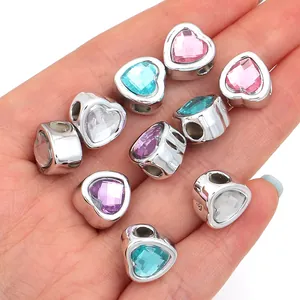 Detailed view of multi-colored heart-shaped resin gemstone beads for jewelry.