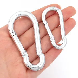 Close-up view of two different sized polished silver zinc alloy snap hooks held in hand