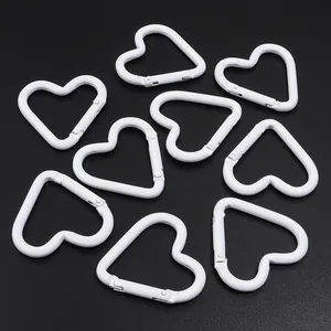 White heart-shaped aluminum carabiners with spring clips for DIY keychain hooks.