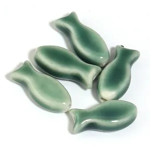 Set of five green glazed ceramic fish-shaped loose beads for handmade DIY jewelry making
