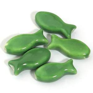 Cute green ceramic fish beads for DIY jewelry making and craft accessories.