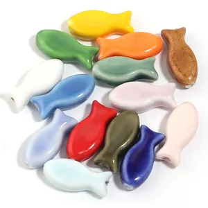 Assorted colorful fish-shaped ceramic loose beads with a polished glaze finish