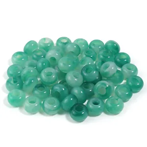 Pile of marbled green acrylic jade-like beads with large holes for DIY jewelry crafts