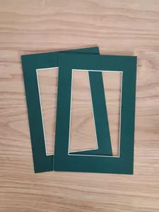Primer plano de dos paspartús verde oscuro de 1 mm de grosor sobre fondo de madera