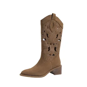 Vintage brown embroidered Western cowboy boots with block heel and V-cut design.