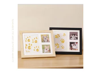 DIY pet paw print keepsake frames with golden clay impressions and pet photos on display