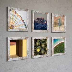 Lot de 6 cadres photo carrés en bois blanc vieilli rustique sur un mur de galerie.