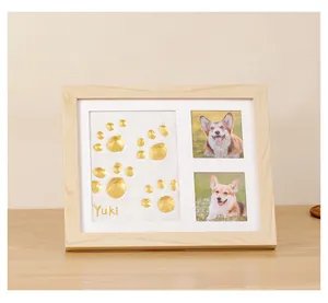 Wooden pet memorial frame with golden paw prints and dog photos