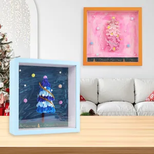 DIY Christmas tree shadow box display frame on wooden table in cozy living room