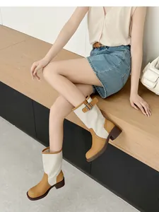 Retro patchwork western cowboy boots for women shown on a model in a lifestyle setting