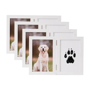 Dettaglio di una doppia cornice in legno bianco per impronte di zampe e foto di cani