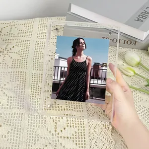 Gros plan d'une main tenant un cadre photo rectangulaire en acrylique transparent