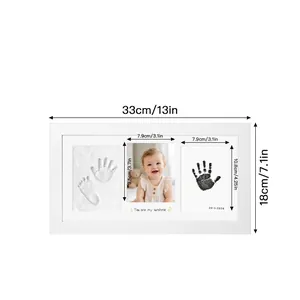 Detailed dimensions of white baby hand and footprint DIY commemorative photo frame (33x18cm).