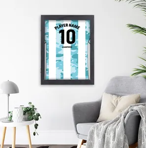 Detailed view of a black jersey display frame mounted in a modern home interior