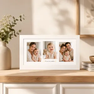 Elegant white three-hole photo frame for baby memories displayed on a wooden shelf