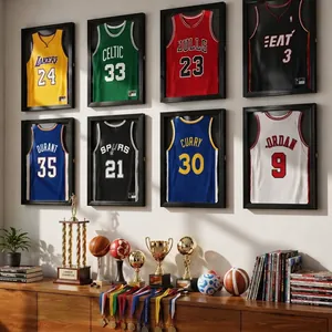 Wall-mounted shadow box frames displaying various sports jerseys and trophies