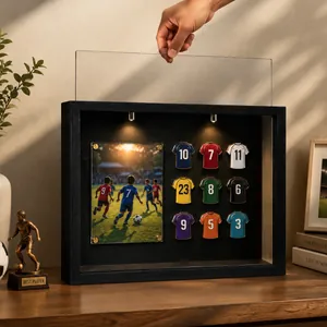 Hand sliding clear acrylic panel into soccer jersey badge shadow box frame with LED lights.