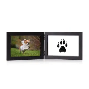 Detailed view of black hinged wooden double photo frame with pet picture and paw print