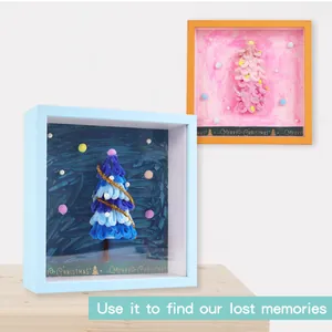 Two DIY Christmas tree shadow box frames with felt doll trees and pearl ornaments