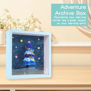Detailed view of a DIY blue Christmas tree shadow box archive frame for festive desktop decoration.