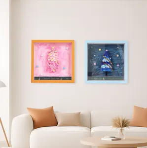 DIY 3D Christmas tree shadow box frames displayed in a cozy modern living room.