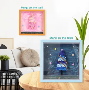 Detailed view of DIY Christmas tree shadow boxes used as hanging and standing home decor