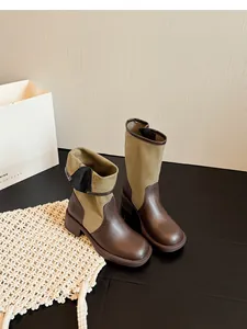 Detail view of retro patchwork fold-over knight boots with brown leather and khaki canvas