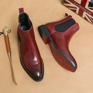 Elegant burgundy pointed-toe Chelsea boots for men with classic red soles and elastic sides