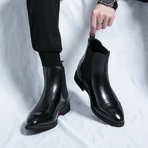 British style black pointed toe Chelsea boots for men with unique red sole detail