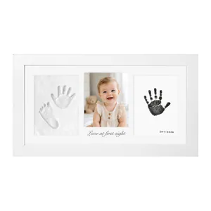 Detailed view of white baby hand and footprint frame with 3D clay and ink pad