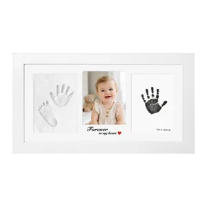 Detailed view of DIY baby hand and footprint memorial frame with clay and ink slots