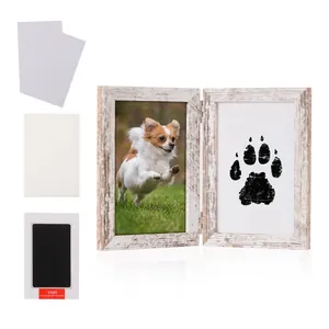 Pet memorial kit with wood frame, paw print pad, and blank cards on white background